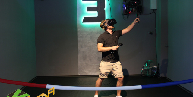 A man in a cordoned off room  with a VR headset